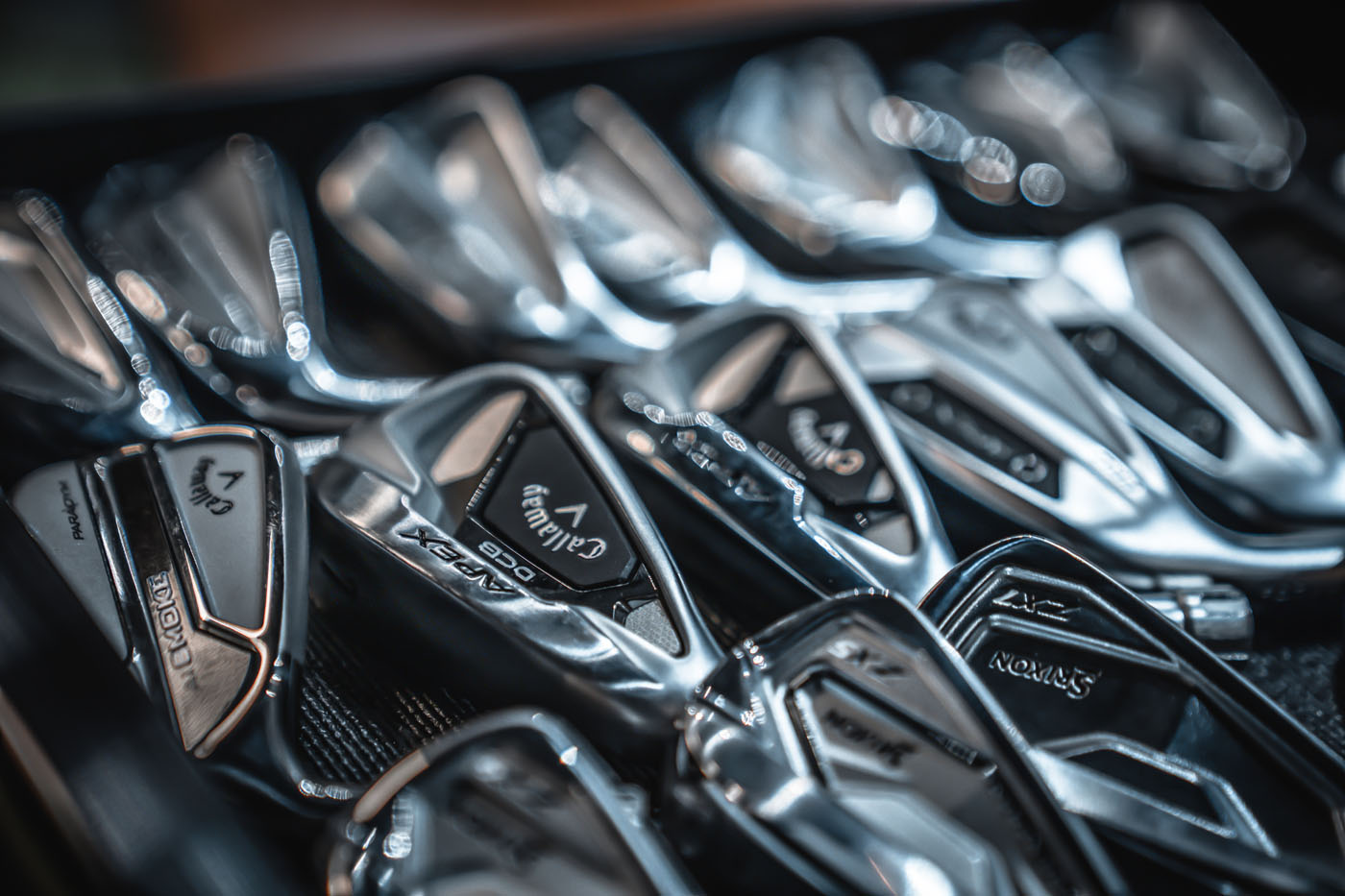 A close-up of golf clubs at Tee Box.