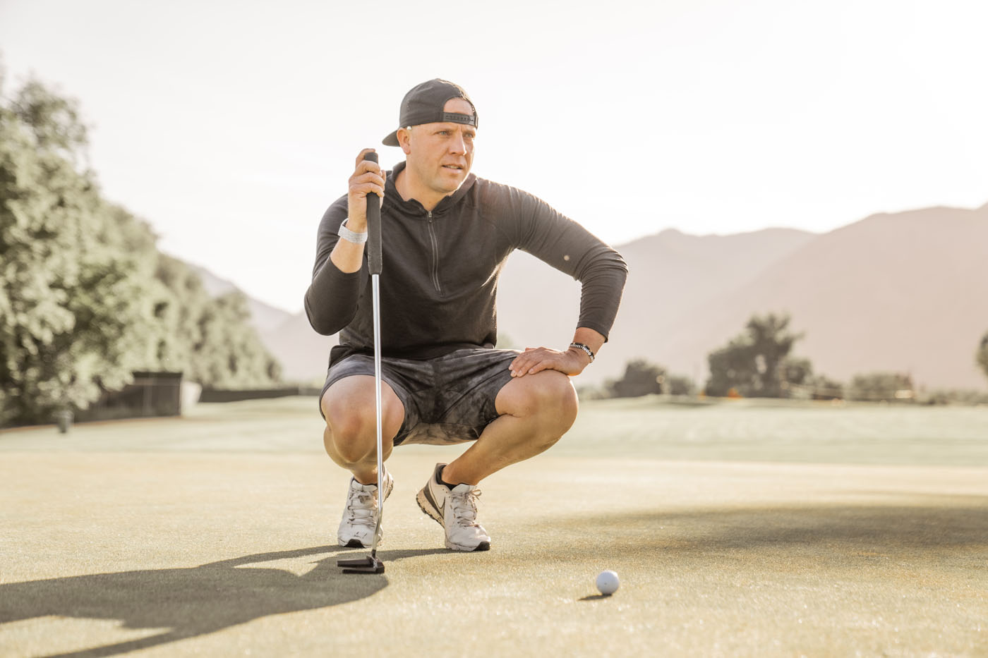 A golfer on a Tee Box outdoor golf course - find support and training you need to become an athlete at our adult golf lessons.