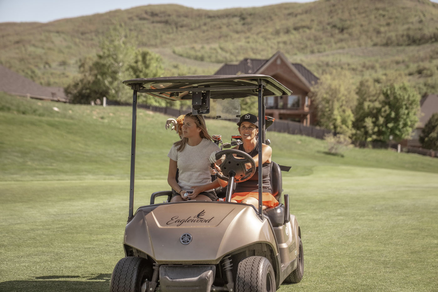 Two Tee Box players in a golf cart in Georgetown, TX.
