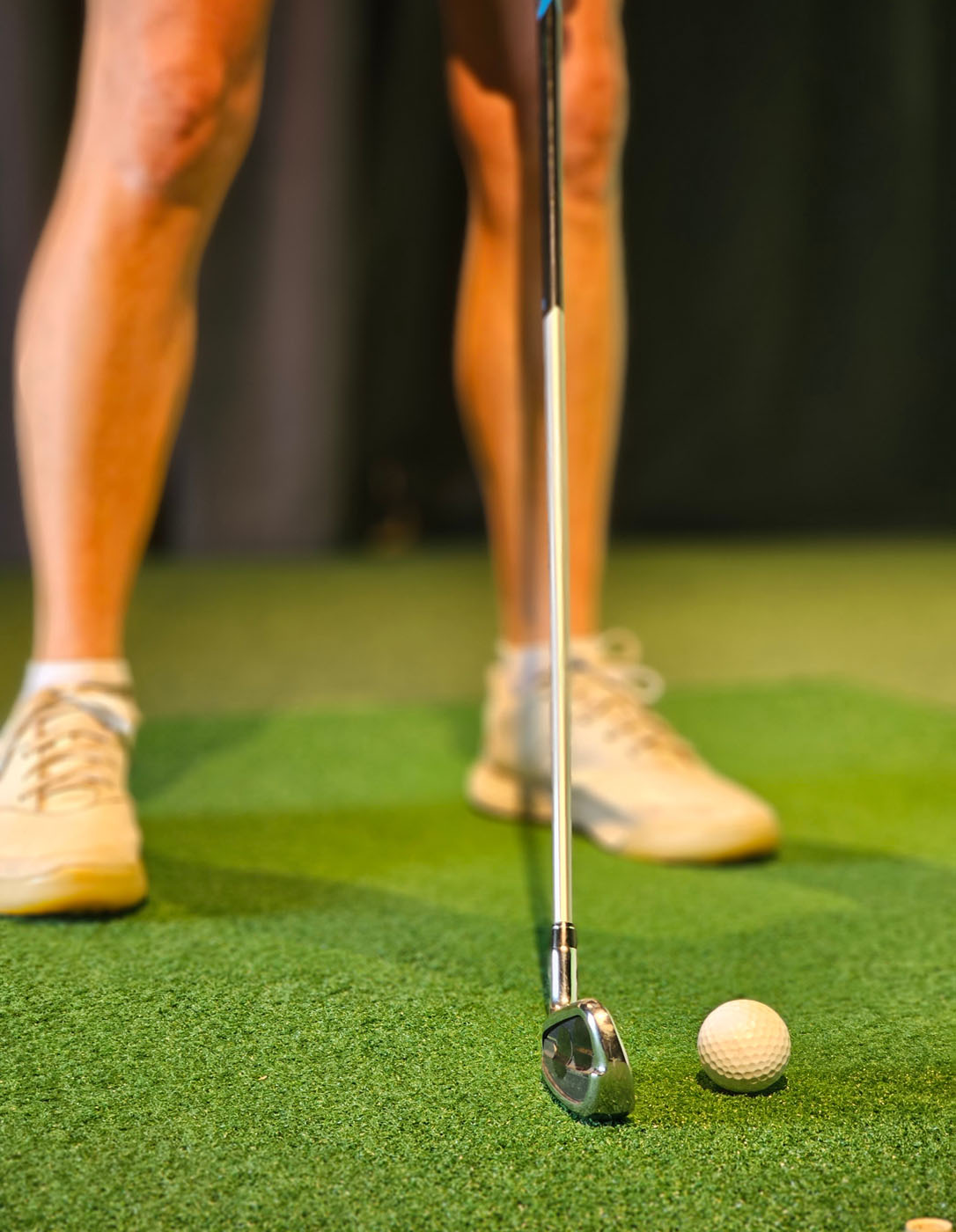 An image of a golf ball and club lined up for a hit at Tee Box Georgetown.