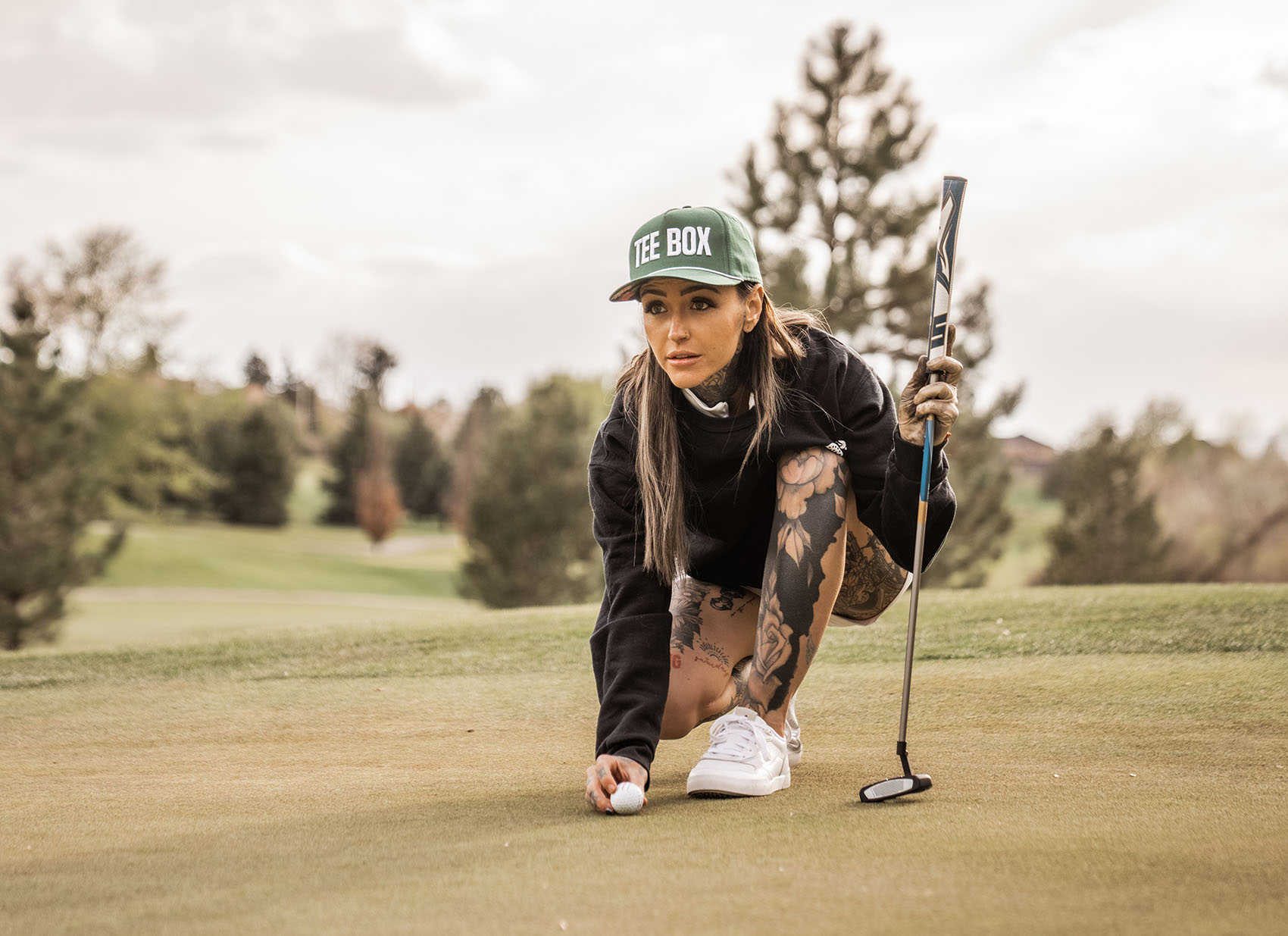 An image of golfer Taylor Nicole lining up a shot on a green in Gilbert, AZ.