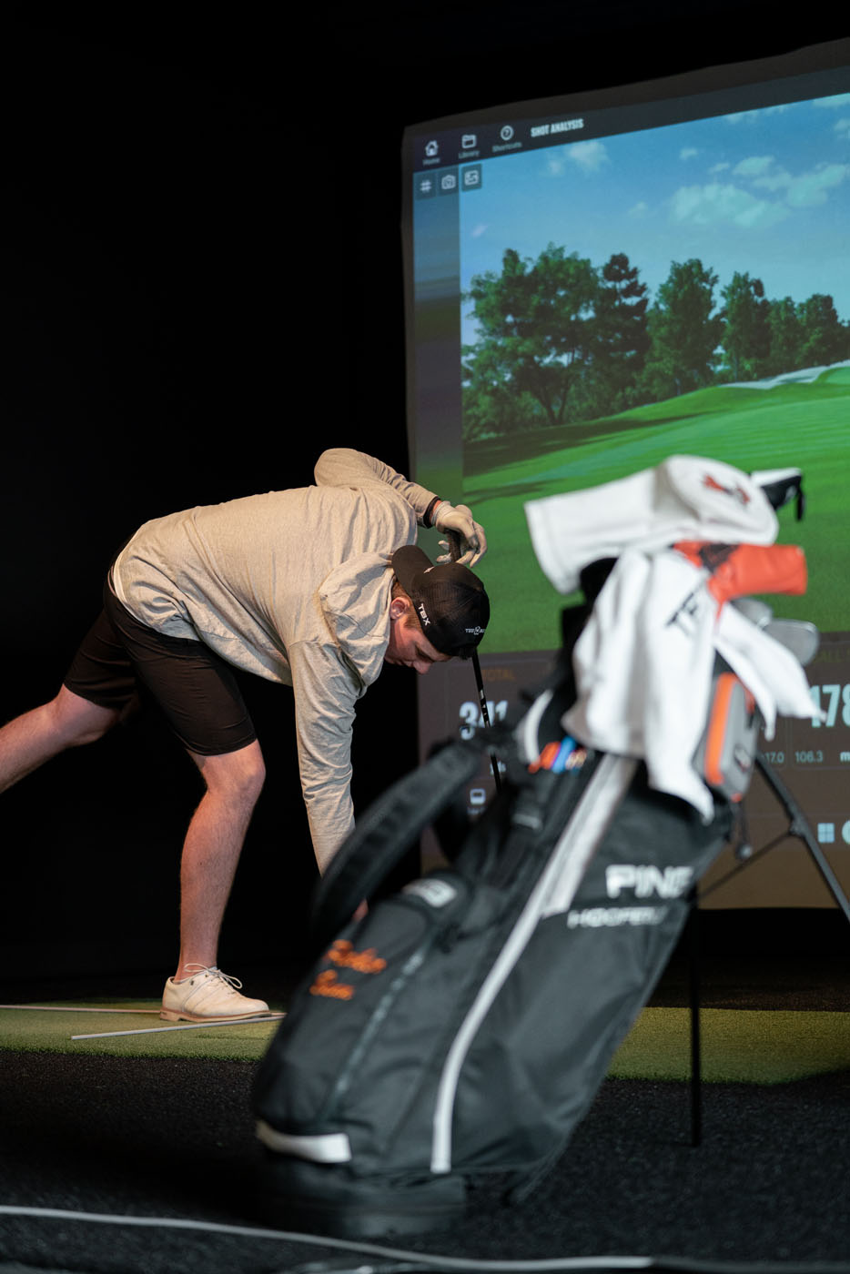 A young Tee Box member getting set up for our indoor virtual golf in St. George, UT.