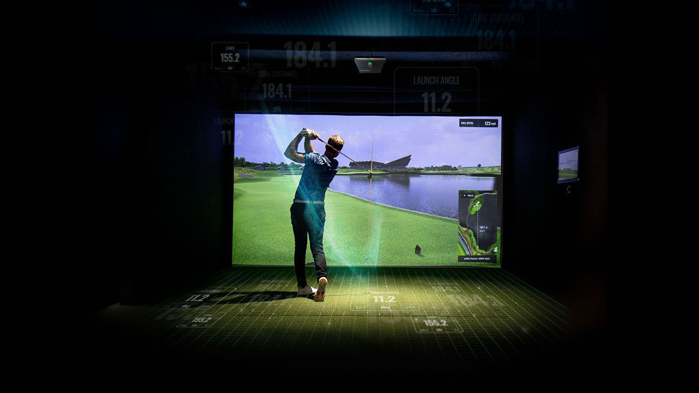 A male Tee Box member practicing his swing on our indoor golf simulator in St. George, UT.