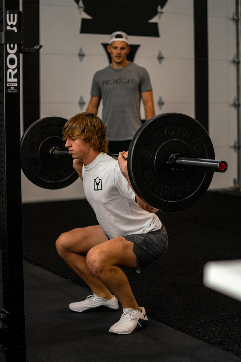 A young adult working out at Tee Box St. George gym.